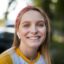 front-view-smiley-woman-with-earbuds